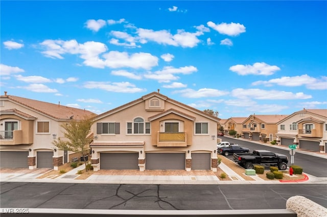 view of front of home featuring a garage, a residential view, and stucco siding