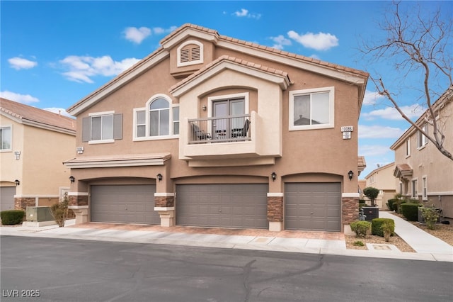 view of front of property featuring a balcony, stone siding, and stucco siding