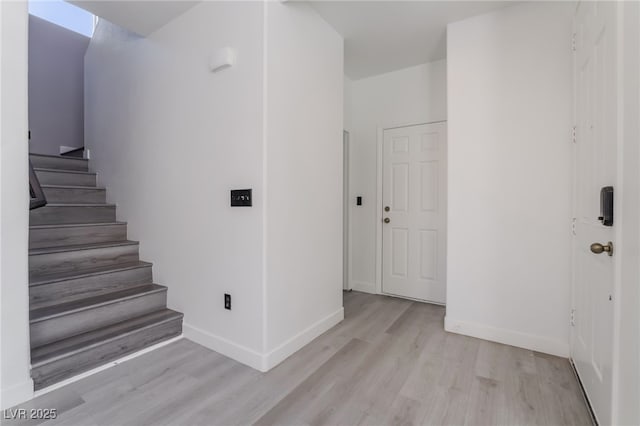 stairway featuring wood finished floors and baseboards