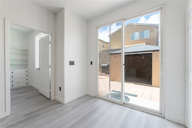 entryway featuring baseboards and wood finished floors