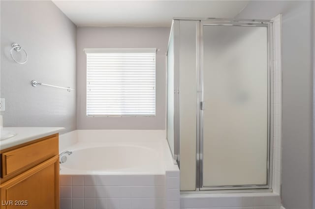 bathroom featuring a bath, a shower stall, and vanity