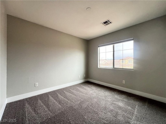 unfurnished room featuring visible vents, baseboards, and carpet flooring