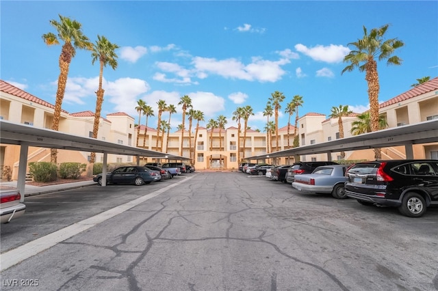 covered parking lot featuring a residential view