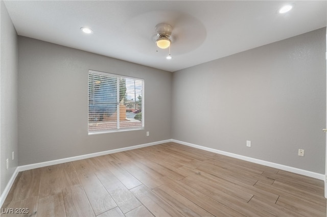 spare room with ceiling fan, baseboards, light wood-style flooring, and recessed lighting