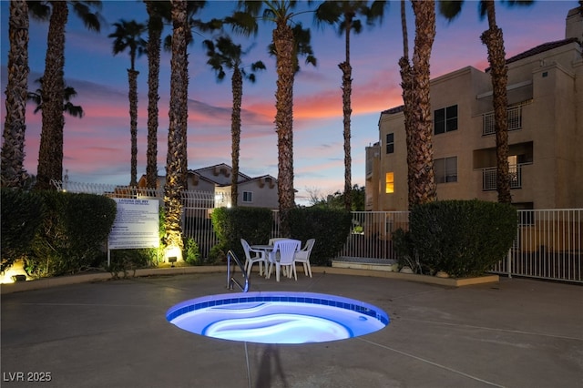 view of pool featuring a community hot tub, a patio, and fence