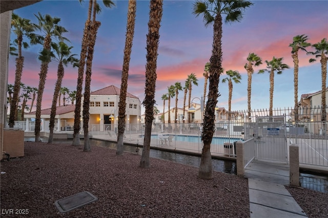 exterior space featuring a community pool and fence