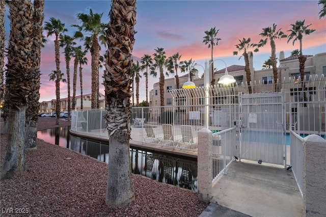 dock area with fence and a water view