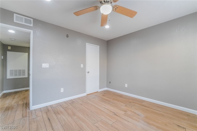 unfurnished room with visible vents, baseboards, and light wood finished floors