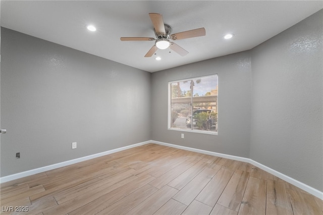 spare room with recessed lighting, light wood-type flooring, baseboards, and ceiling fan