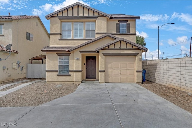 view of front of property with stucco siding, solar panels, and fence