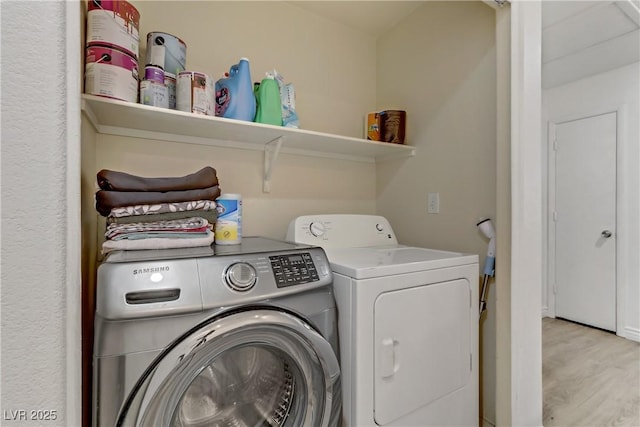 laundry area featuring laundry area, light wood-style floors, and independent washer and dryer