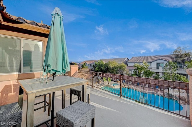 view of patio with a fenced in pool and a residential view