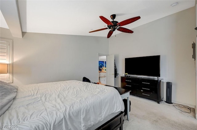 bedroom with light carpet, a ceiling fan, and vaulted ceiling