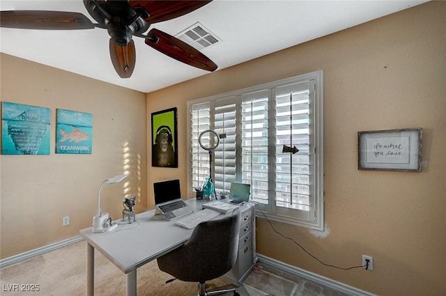 home office with visible vents, baseboards, a ceiling fan, and carpet floors