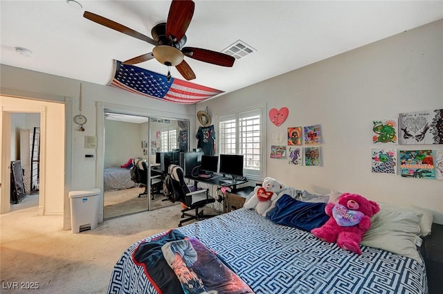 bedroom featuring visible vents, carpet, a closet, and ceiling fan