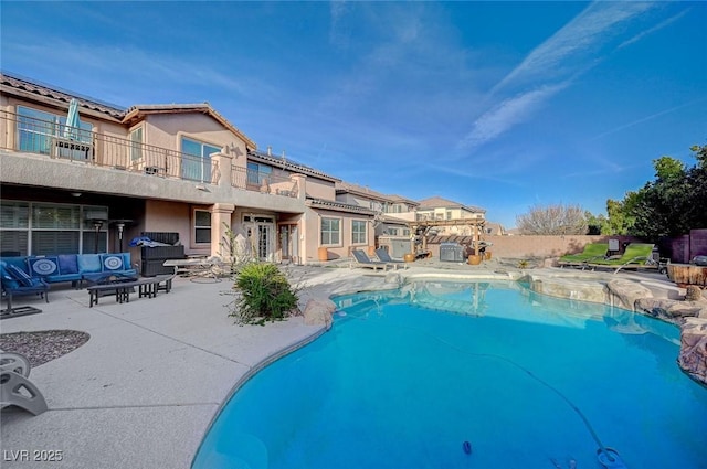 view of swimming pool featuring an outdoor living space, a patio, and a fenced in pool