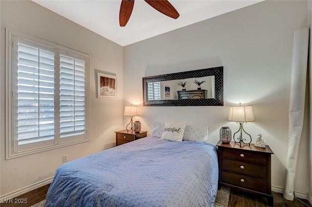 bedroom featuring ceiling fan, baseboards, and wood finished floors