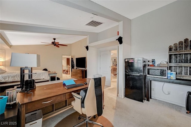 home office featuring carpet, vaulted ceiling, a ceiling fan, and visible vents