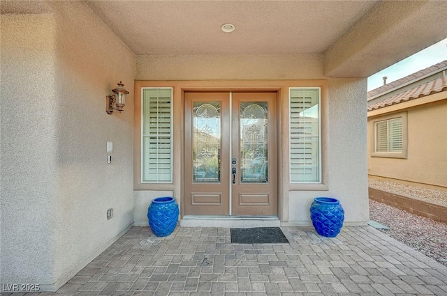 doorway to property with french doors and stucco siding