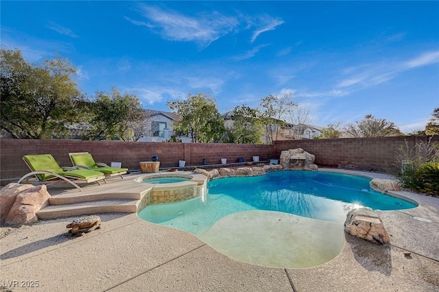 view of swimming pool with a pool with connected hot tub, a patio area, and a fenced backyard