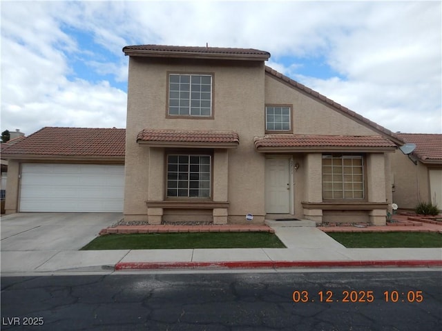 view of front facade featuring a tile roof, concrete driveway, a garage, and stucco siding