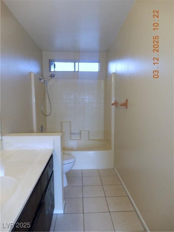 full bath featuring vanity, baseboards, bathtub / shower combination, tile patterned floors, and toilet