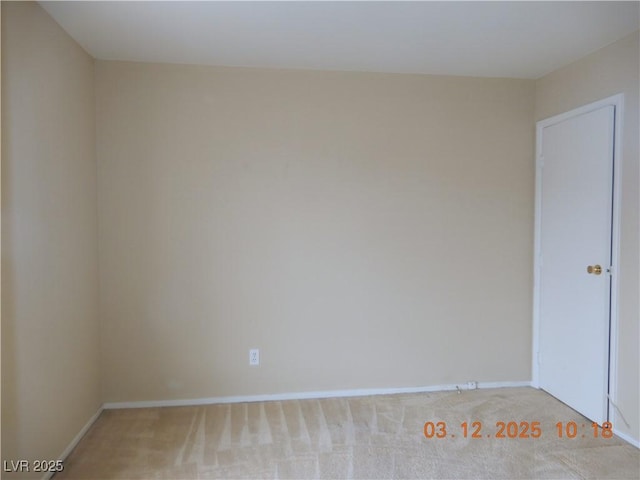 empty room with baseboards and carpet floors