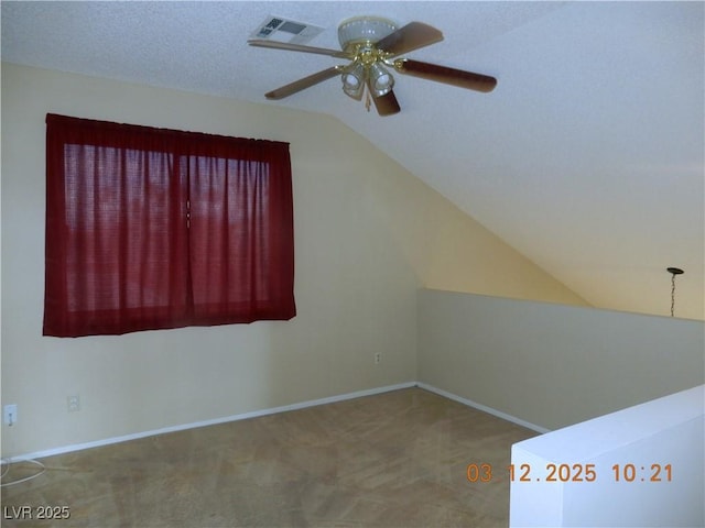 bonus room featuring visible vents, lofted ceiling, ceiling fan, a textured ceiling, and carpet flooring