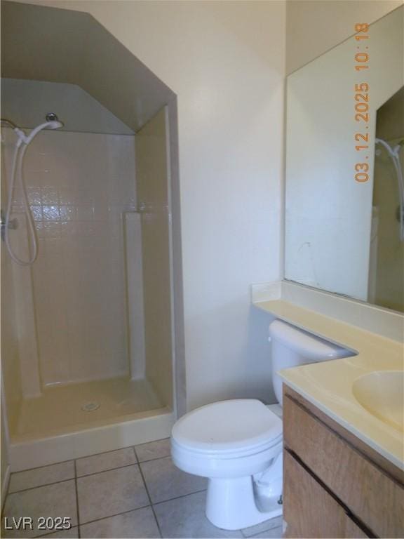 full bathroom featuring vanity, tile patterned floors, toilet, and a shower stall