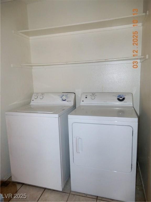 laundry area with laundry area, light tile patterned flooring, and independent washer and dryer