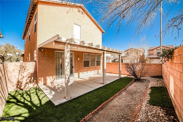 back of property featuring a patio, a fenced backyard, and stucco siding