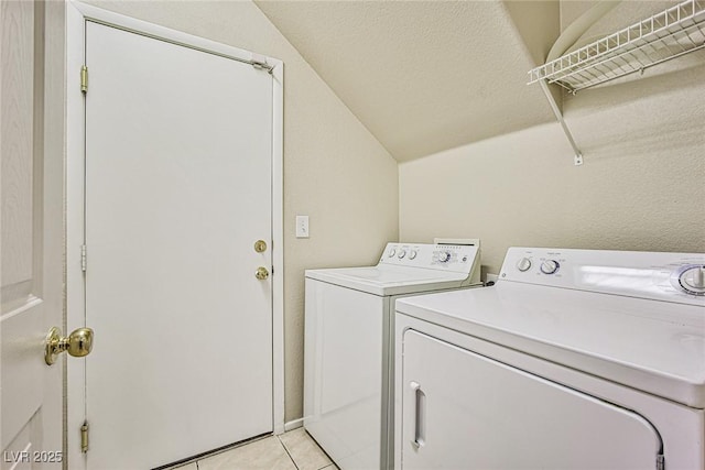 laundry area with light tile patterned floors, laundry area, and independent washer and dryer