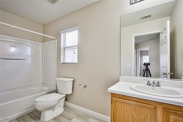 bathroom featuring visible vents, toilet, baseboards, bathtub / shower combination, and vanity