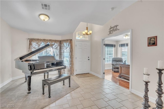 entryway featuring visible vents, baseboards, and a chandelier