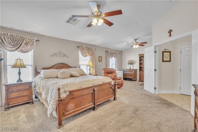 bedroom with light tile patterned floors, a ceiling fan, baseboards, visible vents, and light carpet