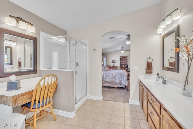 full bath featuring connected bathroom, vanity, a ceiling fan, and a shower stall