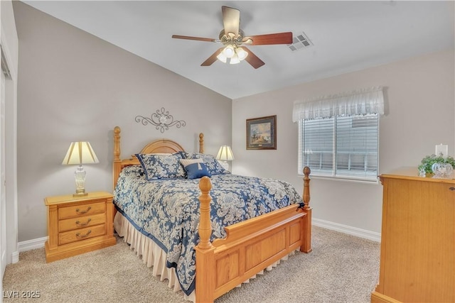 bedroom featuring visible vents, light colored carpet, a ceiling fan, and baseboards