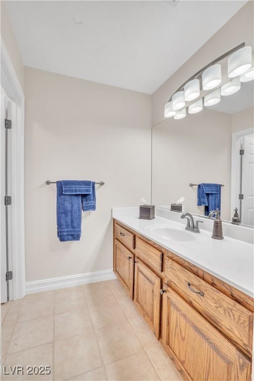 bathroom featuring tile patterned floors, vanity, and baseboards