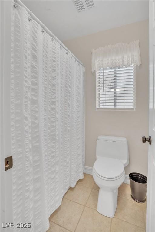 bathroom with visible vents, baseboards, toilet, and tile patterned flooring