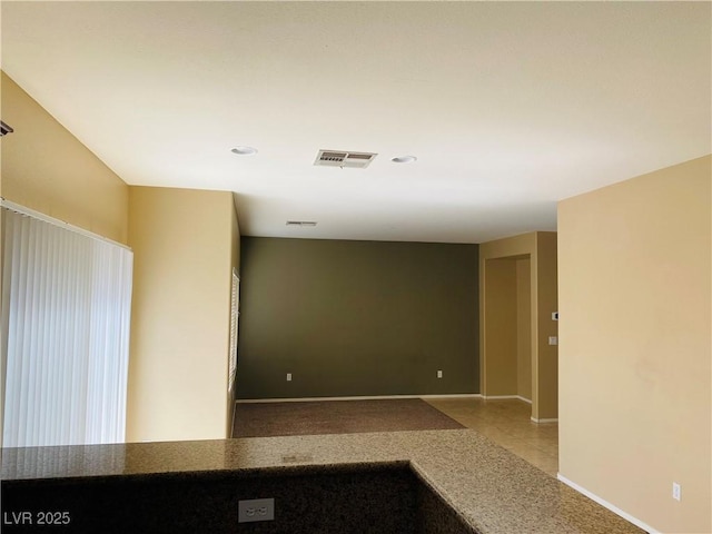 empty room with visible vents, baseboards, and tile patterned flooring