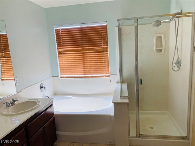 full bathroom featuring tile patterned floors, a garden tub, vanity, and a shower stall