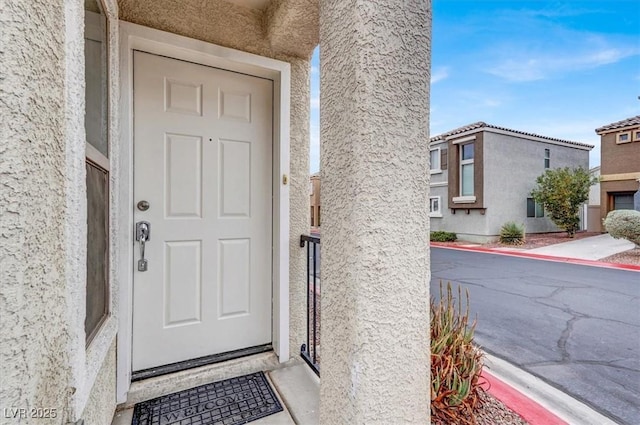 property entrance featuring stucco siding