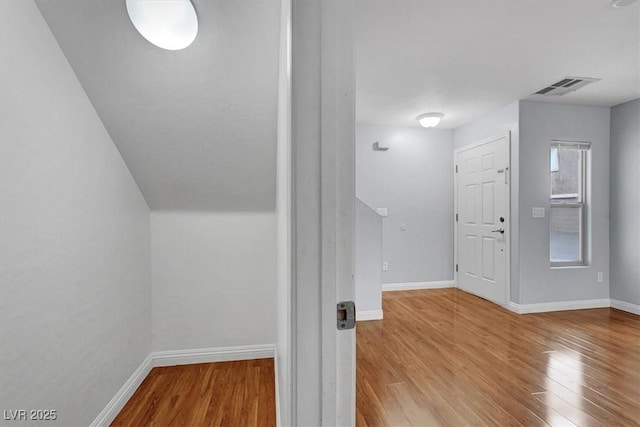 interior space featuring wood finished floors, visible vents, and baseboards