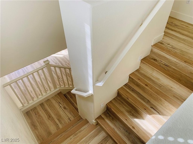 stairway featuring wood finished floors