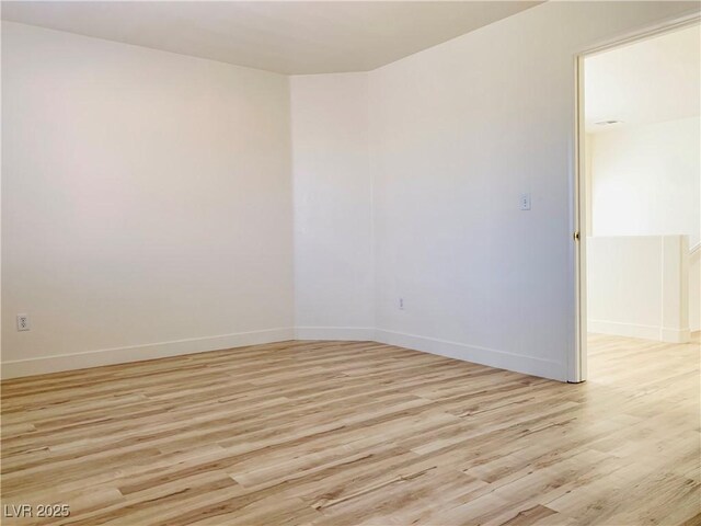 unfurnished room featuring light wood-style floors and baseboards