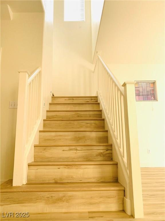 stairway with wood finished floors