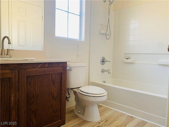 bathroom featuring shower / bath combination, toilet, wood finished floors, and vanity