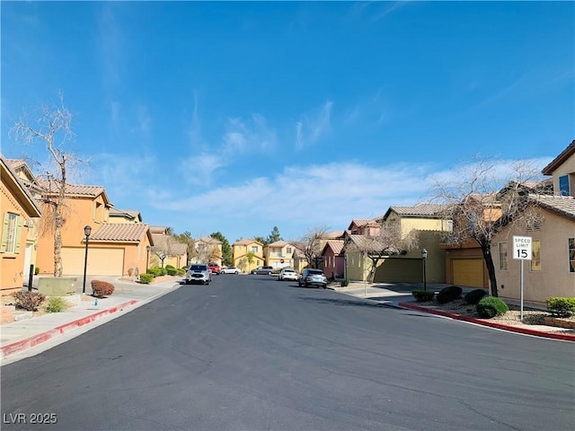 view of street featuring a residential view, curbs, and sidewalks