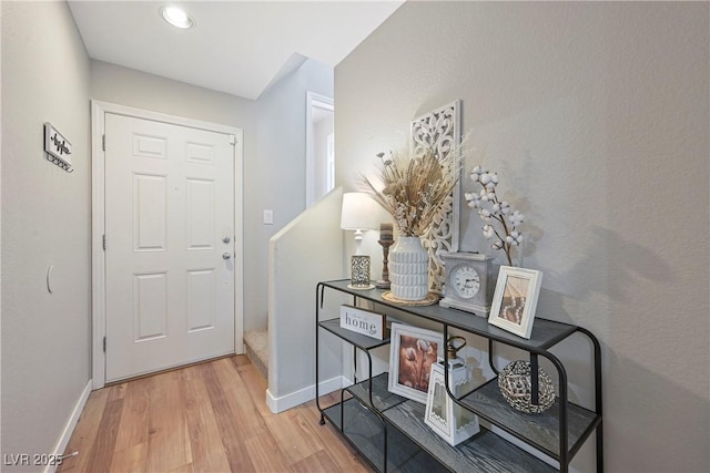 interior space featuring baseboards and wood finished floors