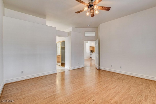 unfurnished room featuring light wood finished floors, ceiling fan, and baseboards